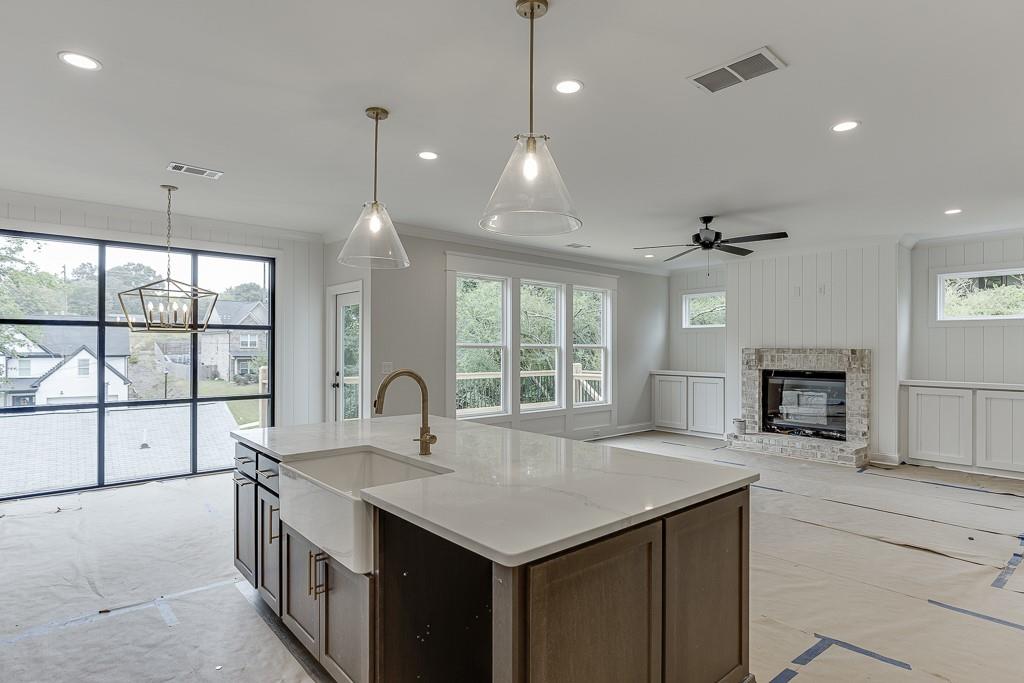 173 Swimming Pool Road Buford, GA 30518 - Photo 16 of 35 a kitchen with granite countertop a sink and a stove top oven