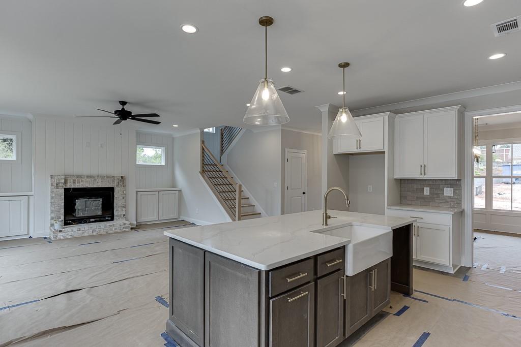 173 Swimming Pool Road Buford, GA 30518 - Photo 17 of 35 a kitchen with kitchen island a sink stainless steel appliances and cabinets