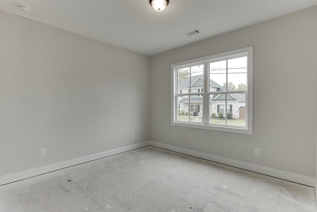 173 Swimming Pool Road Buford, GA 30518 - Photo 21 of 35 an empty room with a window