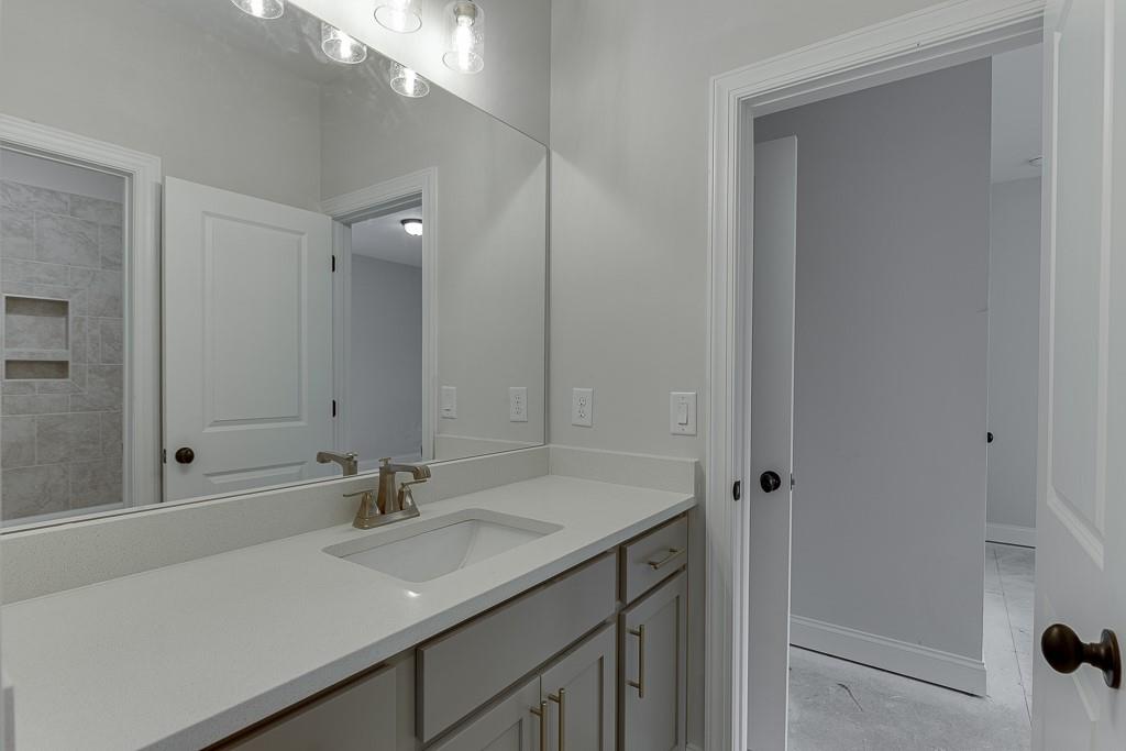 173 Swimming Pool Road Buford, GA 30518 - Photo 24 of 35 a bathroom with a sink and a mirror