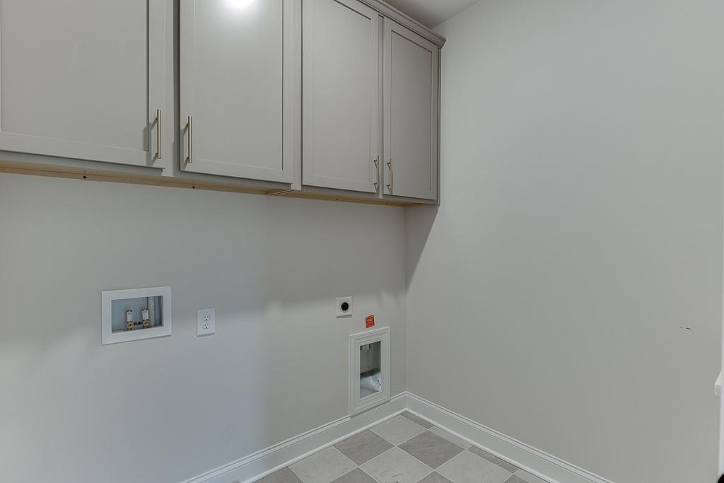 173 Swimming Pool Road Buford, GA 30518 - Photo 28 of 35 a view of storage and utility room with racks on the wall