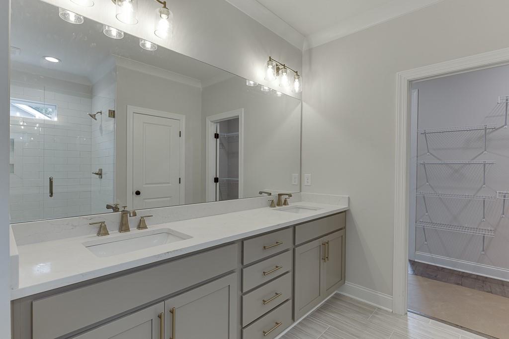 173 Swimming Pool Road Buford, GA 30518 - Photo 32 of 35 a bathroom with double sink and a mirror