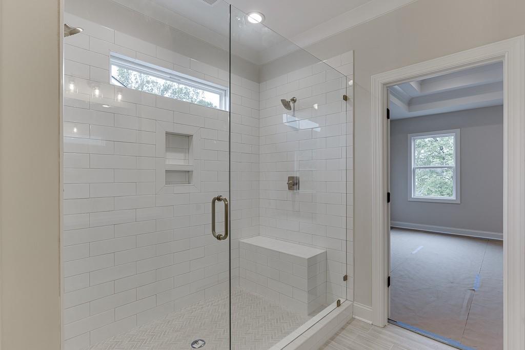 173 Swimming Pool Road Buford, GA 30518 - Photo 33 of 35 a bathroom with a glass shower door
