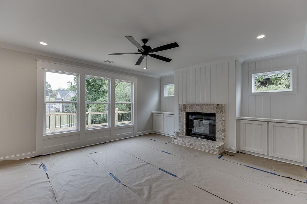 173 Swimming Pool Road Buford, GA 30518 - Photo 9 of 35 an empty room with fireplace and windows