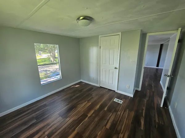 a view of an empty room and wooden floor