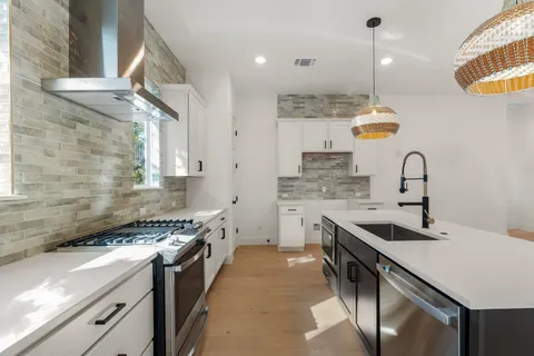 a kitchen with a sink stove and cabinets