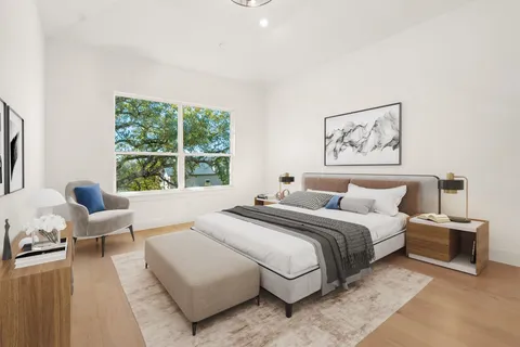 a bedroom with a bed and a large window