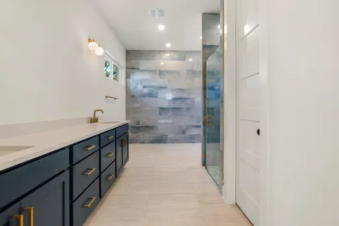 a bathroom with a double vanity sink and a mirror