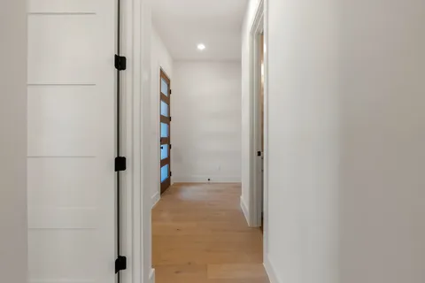 a view of a hallway with wooden shelves
