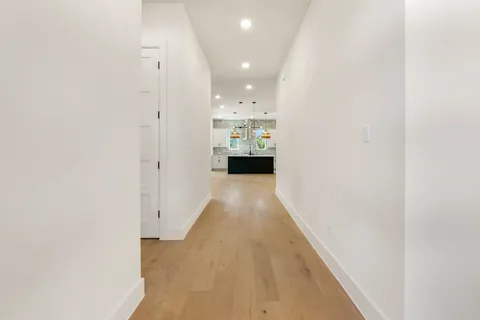 a view of a hallway with wooden floor