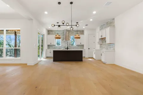 a view of a kitchen with refrigerator and window