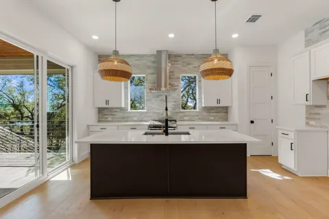 a kitchen with counter top space view and living room view