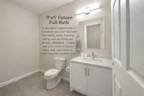 a bathroom with a toilet a sink and a mirror