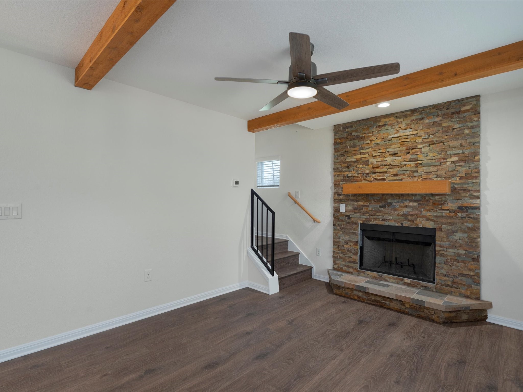 21007 Coleman Branch Creek Road Manor, TX 78653 - Photo 10 of 31 Cozy fireplace with stone surround and wood accents.