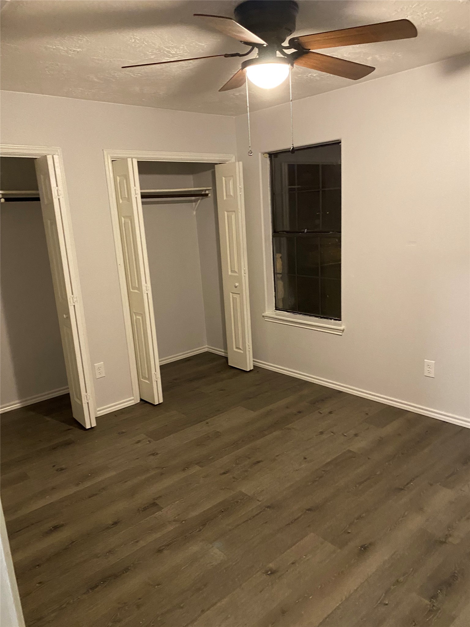 309 South Ave C, Unit A Elgin, TX 78621 - Photo 11 of 15 a view of an empty room with wooden floor and a window