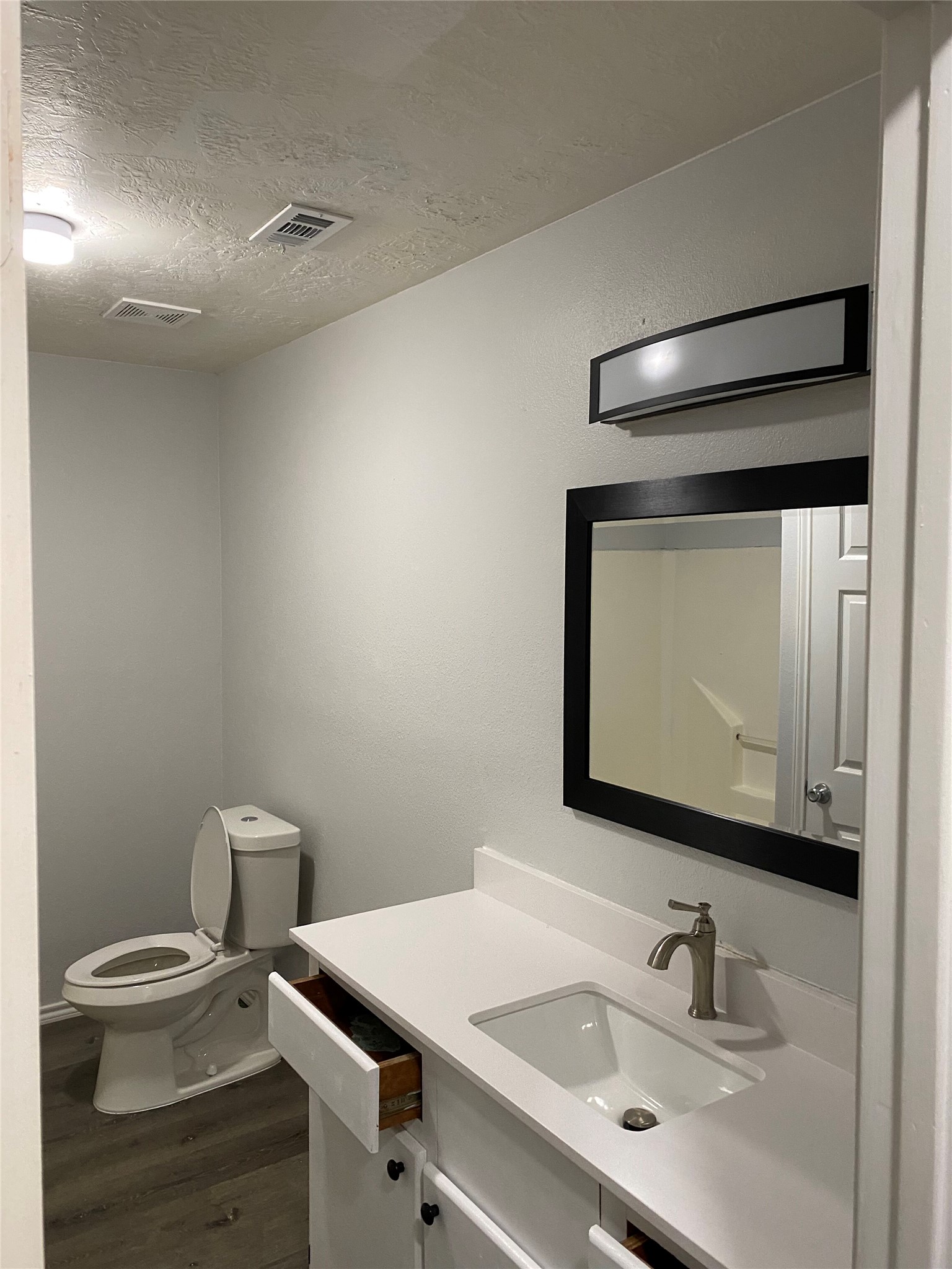 309 South Ave C, Unit A Elgin, TX 78621 - Photo 12 of 15 a bathroom with a sink vanity and toilet