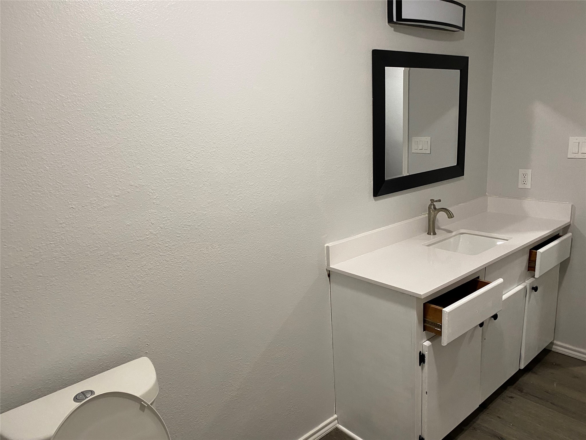309 South Ave C, Unit A Elgin, TX 78621 - Photo 13 of 15 a bathroom with a sink toilet and mirror