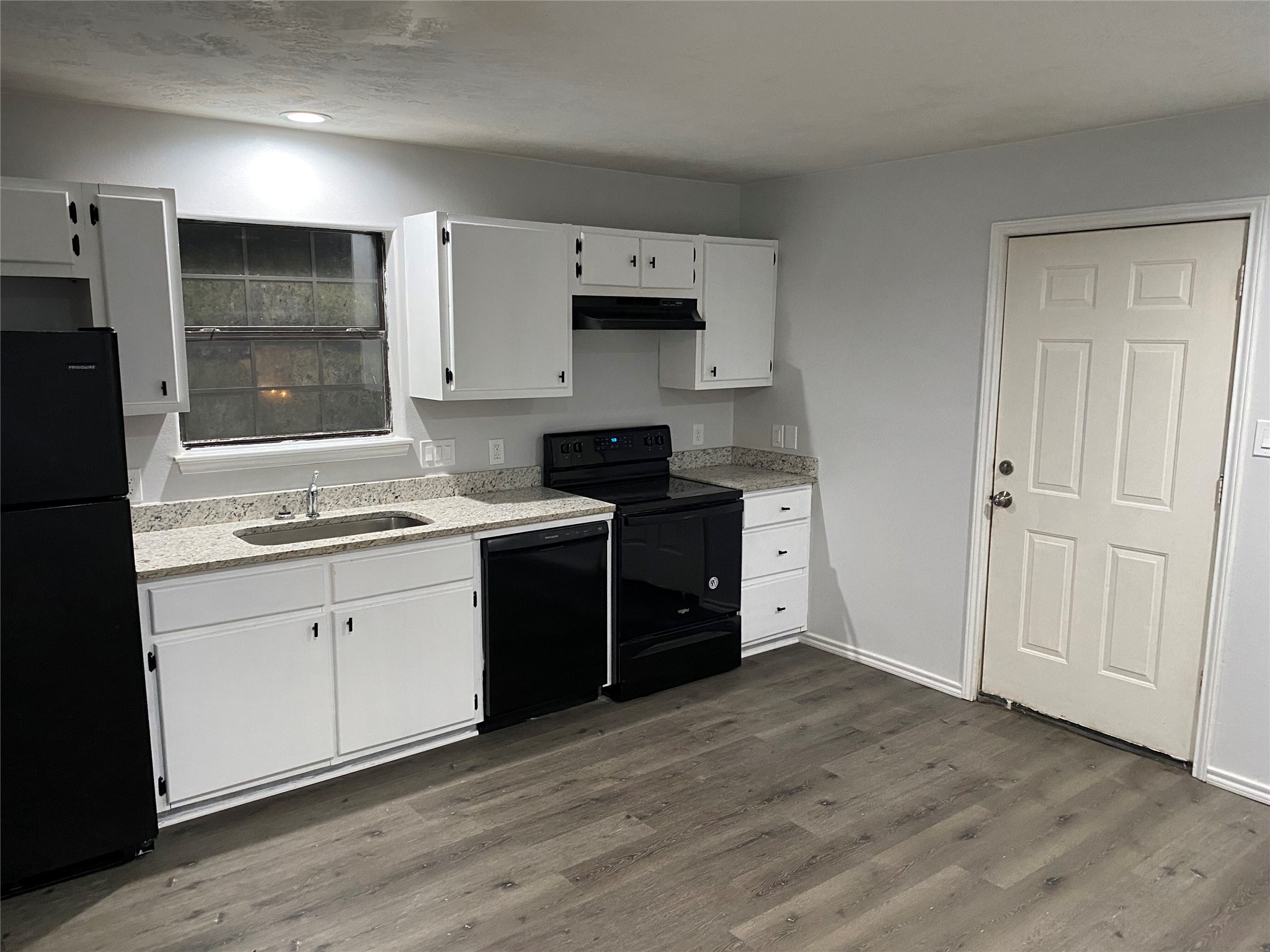 309 South Ave C, Unit A Elgin, TX 78621 - Photo 2 of 15 a kitchen with stainless steel appliances granite countertop a stove a sink and a refrigerator