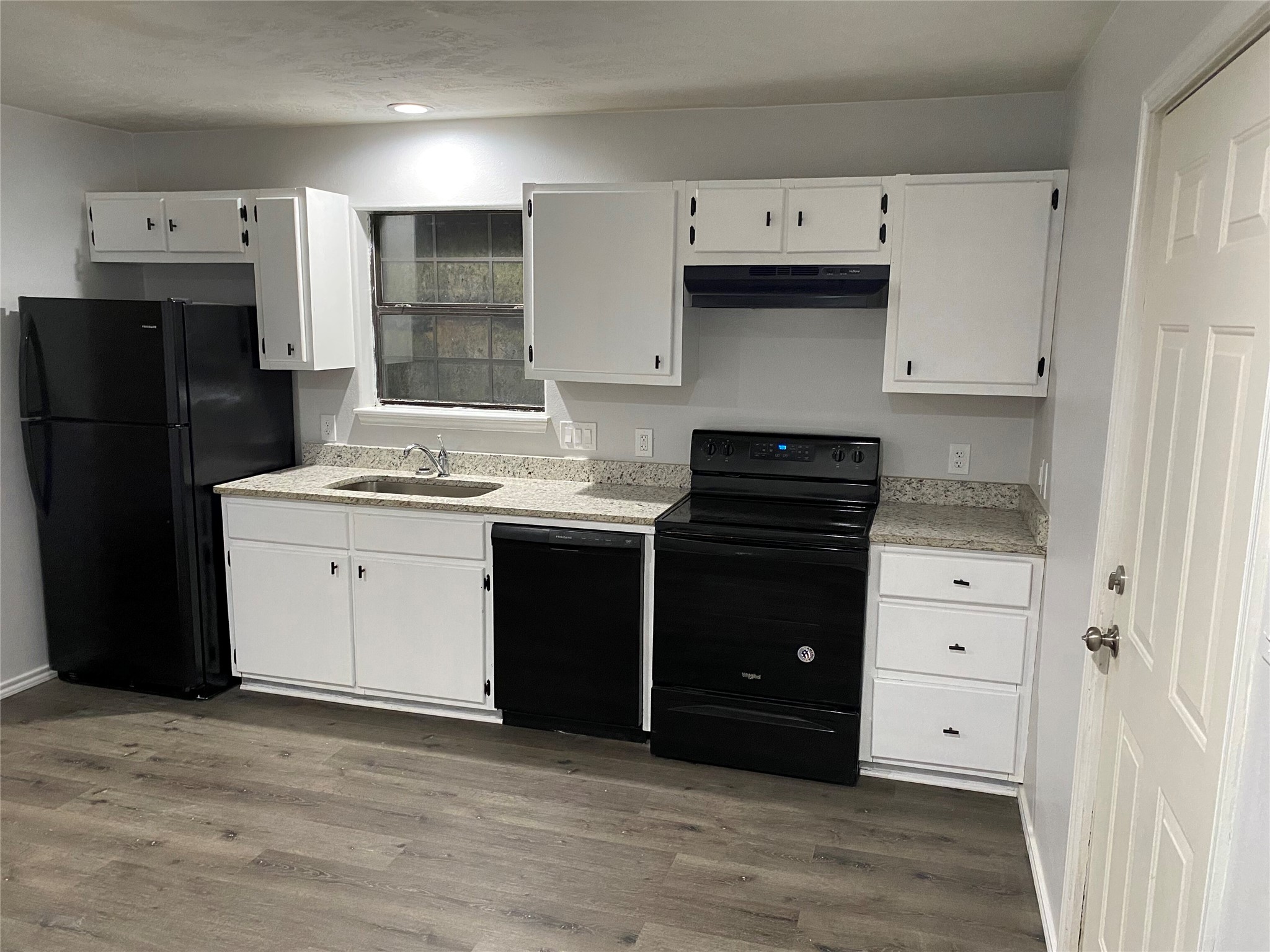 309 South Ave C, Unit A Elgin, TX 78621 - Photo 3 of 15 a kitchen with a refrigerator stove and sink