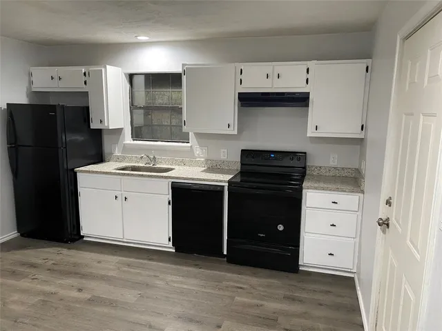 a kitchen with a refrigerator stove and sink