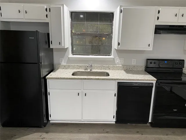 a kitchen with a sink and a refrigerator