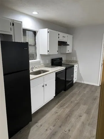 a kitchen with a sink stainless steel appliances and cabinets