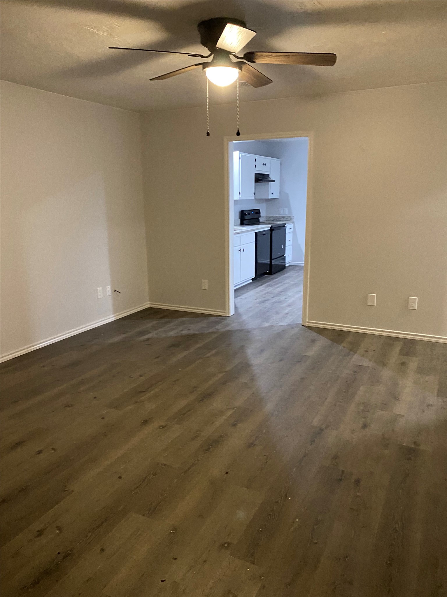 309 South Ave C, Unit A Elgin, TX 78621 - Photo 6 of 15 a view of a kitchen with a sink and a refrigerator