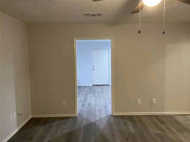 a view of a room with wooden floor