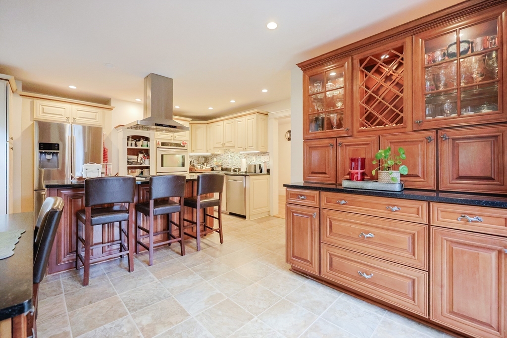 403 Main Street Clinton, MA 01510 - Photo 11 of 42 a open kitchen with stainless steel appliances granite countertop a table and chairs in it