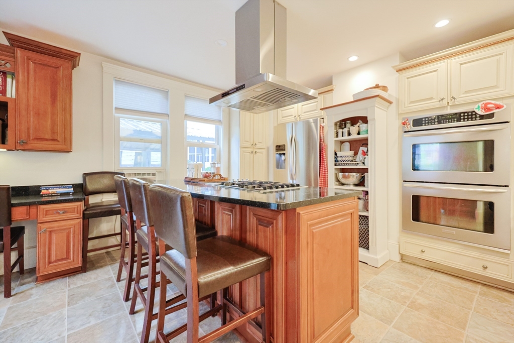 403 Main Street Clinton, MA 01510 - Photo 13 of 42 a open kitchen with stainless steel appliances granite countertop a stove a sink dishwasher and a refrigerator with wooden cabinets