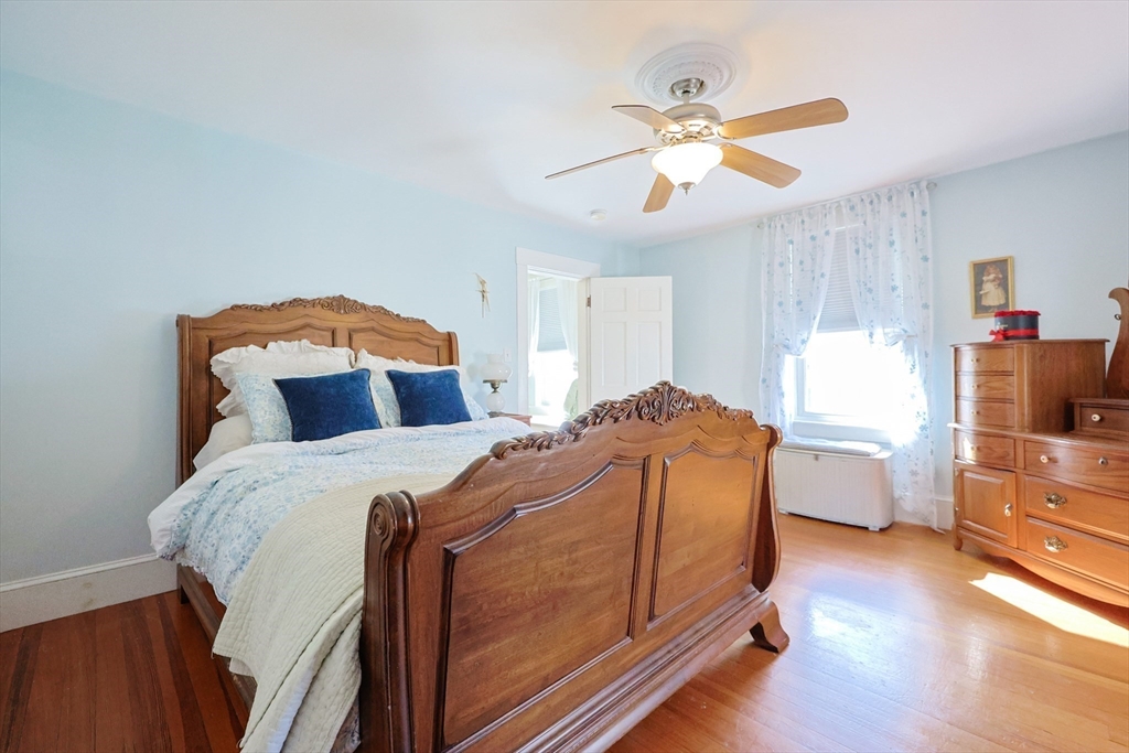 403 Main Street Clinton, MA 01510 - Photo 23 of 42 a bed room with a bed and a ceiling fan