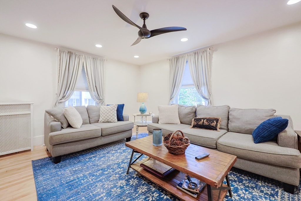 403 Main Street Clinton, MA 01510 - Photo 7 of 42 a living room with furniture a rug and a chandelier