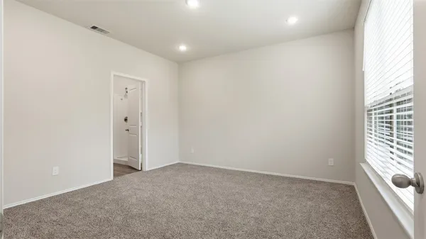 a view of an empty room and a window