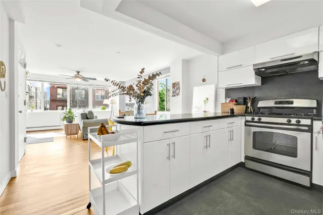 a kitchen with stainless steel appliances granite countertop a stove and cabinets