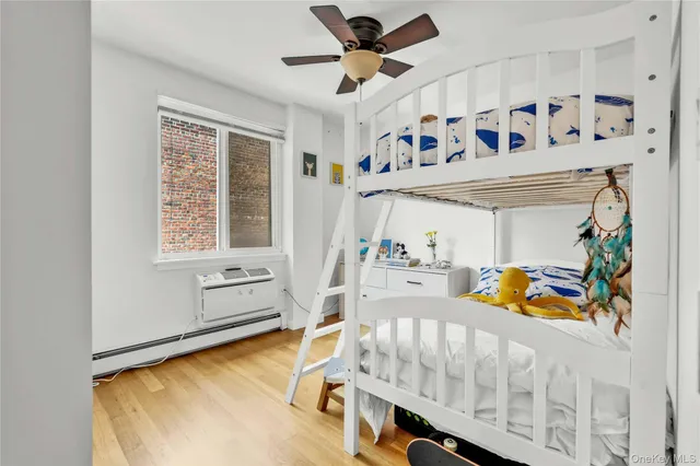 a bedroom with furniture and a large window