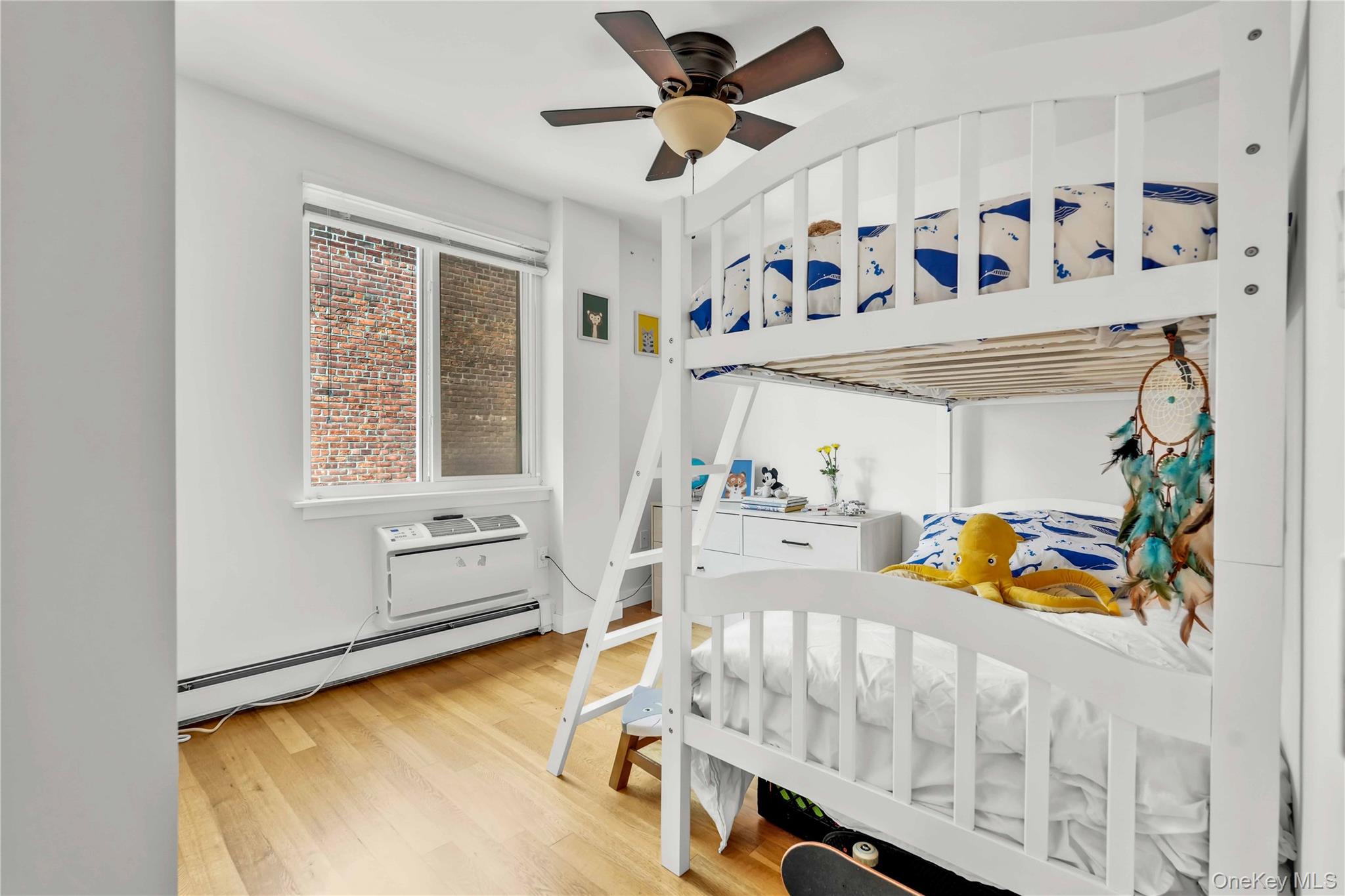 30-80 47th Street, Unit 3A Queens, NY 11103 - Photo 14 of 31 a bedroom with furniture and a large window