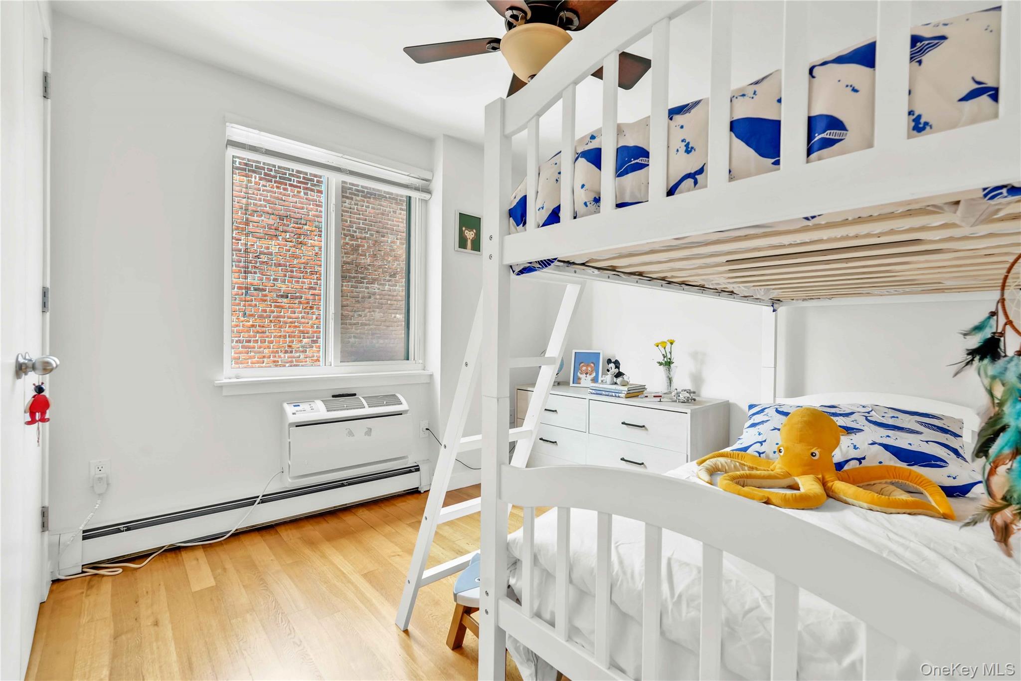 30-80 47th Street, Unit 3A Queens, NY 11103 - Photo 15 of 31 a bed room with a bed and a baby crib