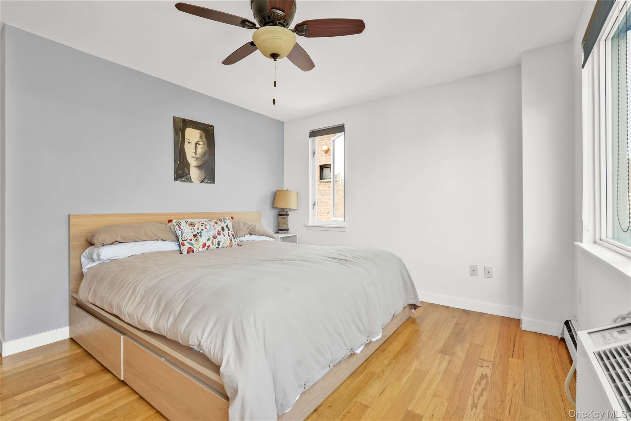 30-80 47th Street, Unit 3A Queens, NY 11103 - Photo 18 of 31 a bedroom with a large bed and a chandelier