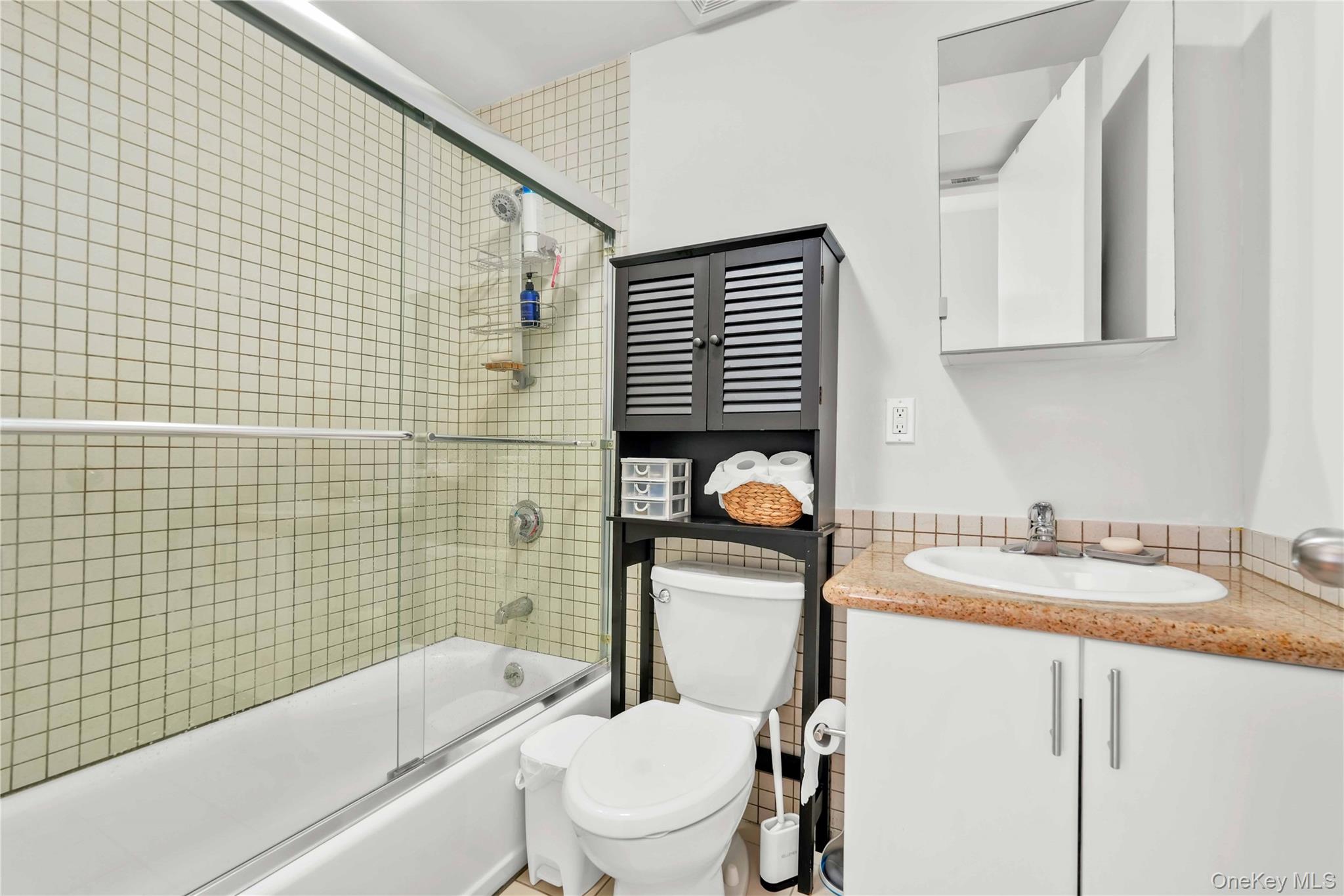 30-80 47th Street, Unit 3A Queens, NY 11103 - Photo 20 of 31 a bathroom with a granite countertop sink toilet and shower