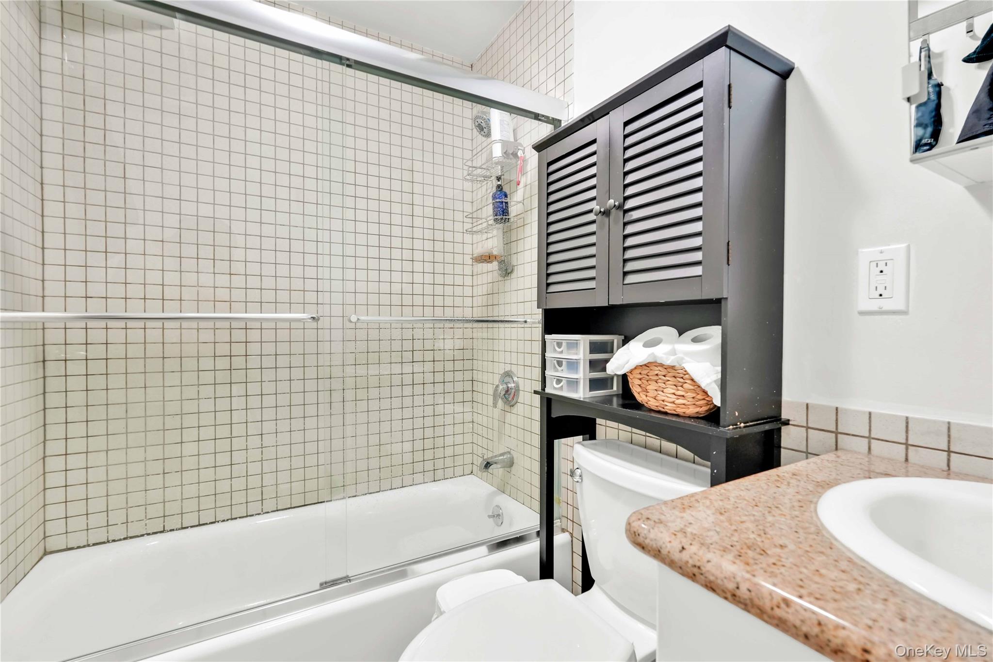 30-80 47th Street, Unit 3A Queens, NY 11103 - Photo 21 of 31 a bathroom with a granite countertop sink and a bathtub