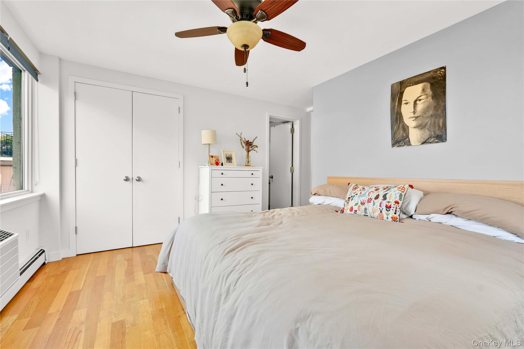30-80 47th Street, Unit 3A Queens, NY 11103 - Photo 22 of 31 a bedroom with a bed and a chandelier