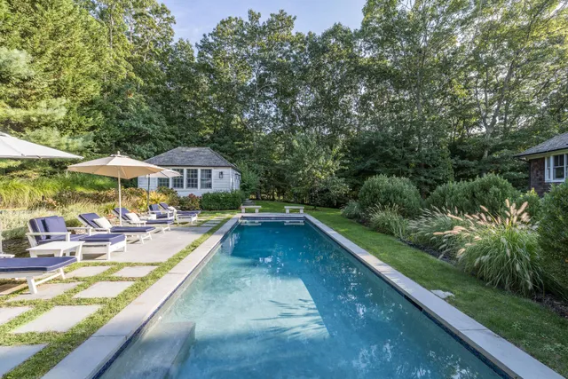 swimming pool view with a seating space