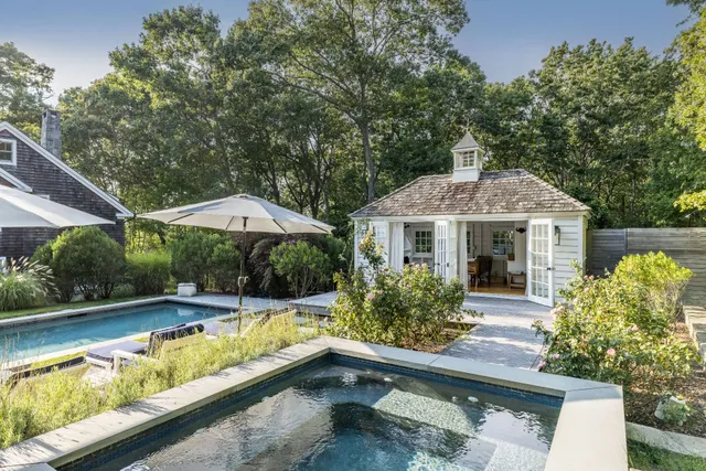swimming pool view with a seating space