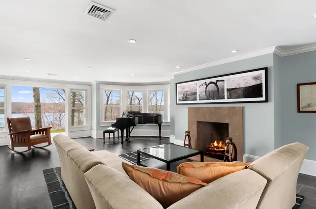 a living room with furniture and a fireplace