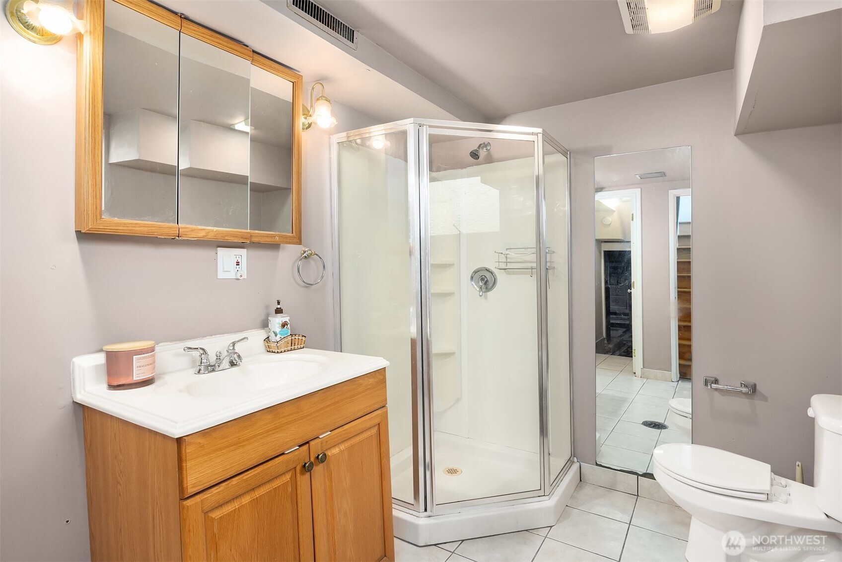 15411 Southeast 8th Street Bellevue, WA 98007 - Photo 12 of 24 a bathroom with a sink mirror vanity and toilet