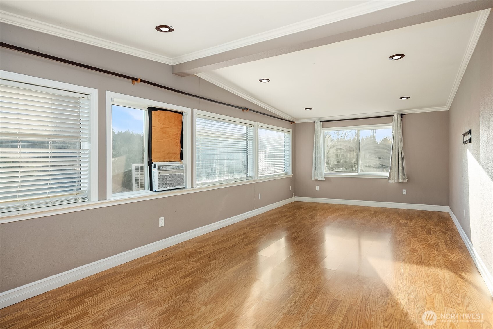 15411 Southeast 8th Street Bellevue, WA 98007 - Photo 9 of 24 a view of an empty room with wooden floor and a window