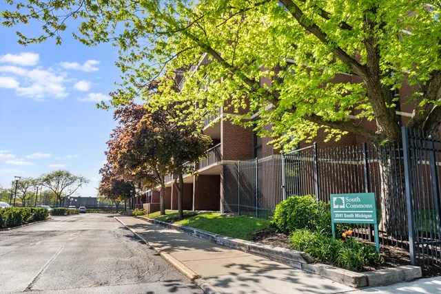 a view of a house with a tree in front of it