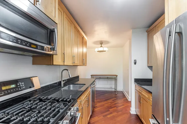 a kitchen with stainless steel appliances granite countertop a stove and a refrigerator