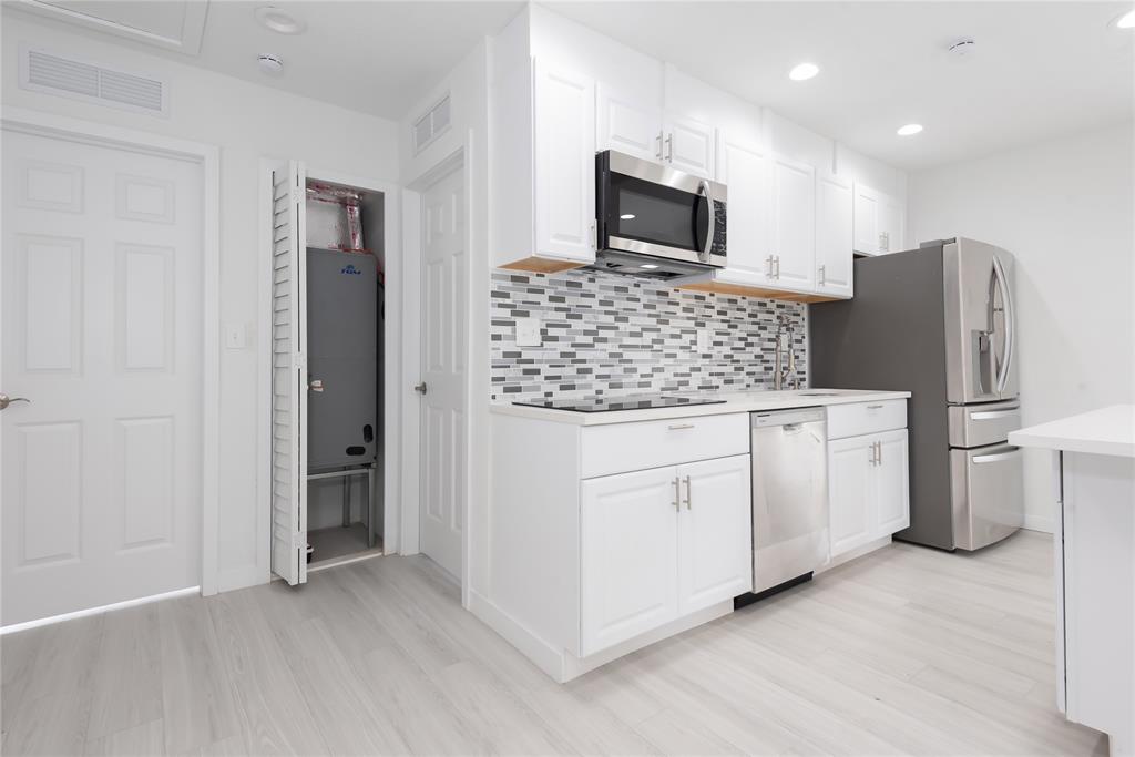 713 Southwest 4th Court Hallandale Beach, FL 33009 - Photo 11 of 38 a kitchen with stainless steel appliances a refrigerator and microwave
