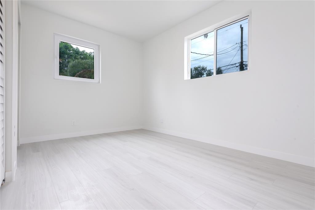 713 Southwest 4th Court Hallandale Beach, FL 33009 - Photo 16 of 38 an empty room with windows and closet